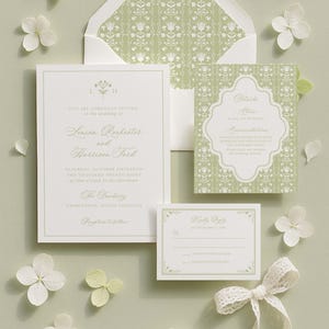 A formal wedding invitation featuring a white and green color scheme, with floral accents and a lace ribbon.