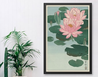 May include: A vintage Japanese woodblock print of pink water lilies with green leaves on a light blue background. The print is framed in black and has a Japanese character in the bottom right corner.
