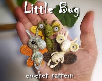 May include: Four crocheted bug toys with large eyes. The bugs are green, gray, white, and brown. The bugs are holding a sign that says "Little Bug crochet pattern".