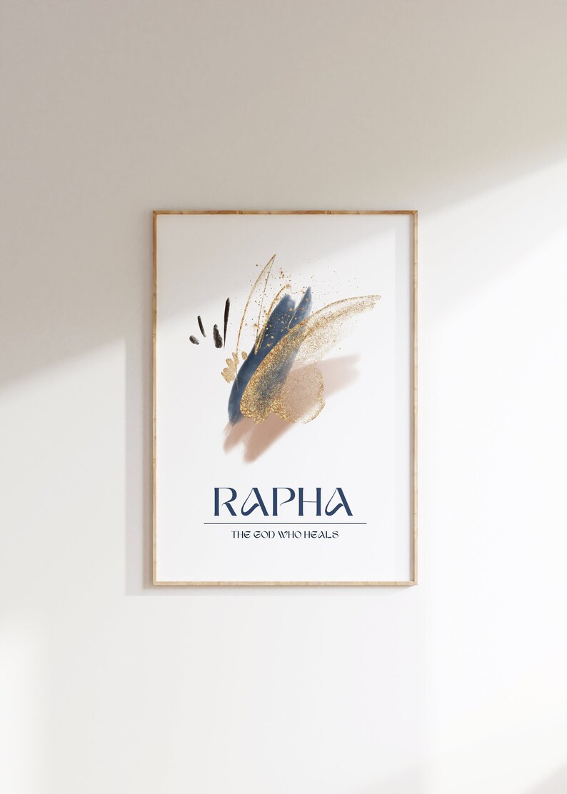 May include: Framed art print featuring abstract brushstrokes in navy blue, gold, and beige. The word "RAPHA" is displayed in navy blue, with "THE GOD WHO HEALS" below it. The artwork is in a gold frame.