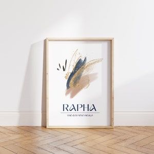 May include: A framed art print with abstract brushstrokes in navy blue, gold, and tan. The word "RAPHA" is printed in navy blue, with "THE GOD WHO HEALS" below it. The frame is light wood.