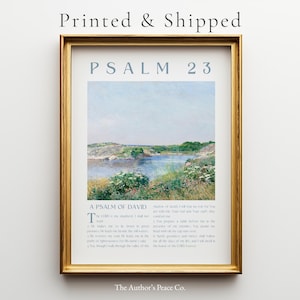 May include: A framed print with a gold-colored frame. The print features a landscape painting of a river and greenery, with the text "PSALM 23" at the top. Below the painting is the text "A PSALM OF DAVID" and a passage from the Bible.