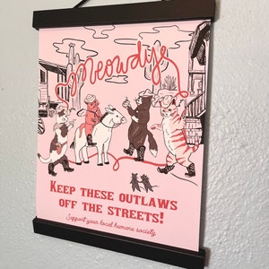 Original Meowdy Print pictured with poster rails