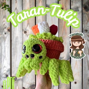 May include: A green crocheted spider with large red eyes and a flower pot on its back. The flower pot has orange, white, and red accents. The text "Taran-Tulip" is in a green bubble font. The words "Intermediate Crochet Pattern" are at the bottom.