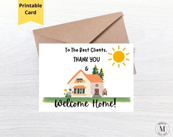 May include: A white greeting card with a brown envelope featuring a house illustration with an orange roof, green trees, and a yellow sun. The text reads: To The Best Clients, THANK YOU & Welcome Home! A yellow banner at the top says Printable Card.