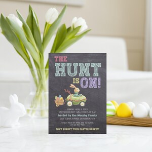 May include: A chalkboard-style invitation for an Easter egg hunt. The invitation features a cartoon bunny in a green car with a wagon full of colourful eggs. The text reads "The Hunt is On!" and includes details about the event, including the date, time, location, and host.