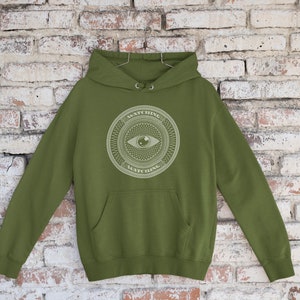 The dollar watching eye money shirt! On an army green hoodie!