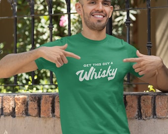 May include: A green t-shirt with the text "Get this guy a Whisky" in white lettering.