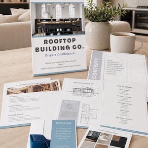 May include: A Rooftop Building Co. Buyers Guidebook with a cover showing a kitchen interior, accompanied by several informational sheets including a ranch floor plan, standard home features, designer selections, and a list of partners.