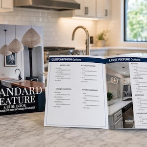 May include: A Standard Feature Guide Book with a cover showing a kitchen interior and an open interior page displaying Custom Finish Options and Light Fixture Options. The text includes headings for backsplash, kitchen flooring, counters, and hardware.