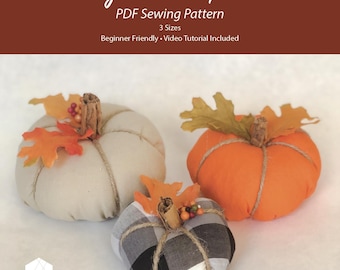 May include: A PDF sewing pattern titled Easy Fall Pumpkins featuring three fabric pumpkins in beige, orange, and black and white buffalo check. Each pumpkin is topped with a cinnamon stick stem, faux autumn leaves, and twine.