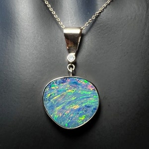 Australischer Opal Anhänger mit Feuer geladen, gefasst in massivem 585er Gelbgold mit diamantbesetzter Anhängeröse. Freeform australischer Opal Anhänger.