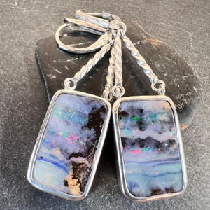 Australian boulder opal earrings set in sterling silver. Blue, orange, red, green in these all natural boulder opal drop earrings.