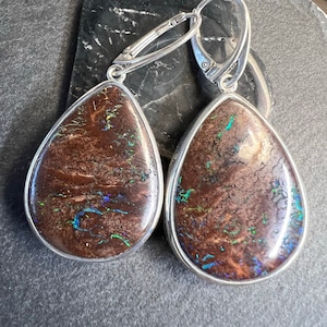 Large teardrop boulder opal earrings. Australian boulder opal earrings set in sterling silver with lever back closures.