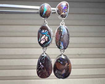 Koroit boulder opal earrings set in sterling silver with pushbacks. Australian boulder opal earrings with great play of color!