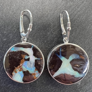 Brown and round, boulder opal dangle, drop earrings. Brown boulder opal with ribbons of opal inlayed in sterling silver with lever backs.