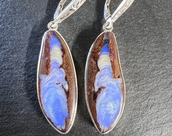 Blue boulder opal drop earrings set in sterling silver. Freeform lever back boulder opal drop earrings set in silver.