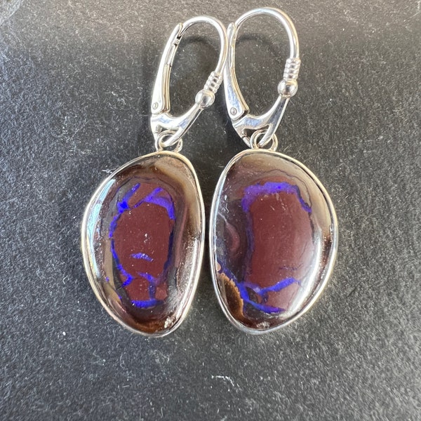 Dark boulder opal drop earrings with ribbons of royal blue/purple opal set in sterling silver with lever back closure.