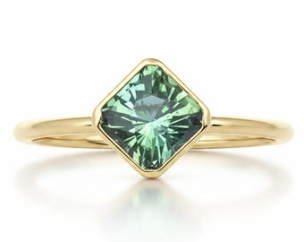 Minty green  precision cut square tourmaline bezel set diagonally in 14k yellow gold.