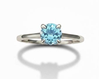 3/4 Carat Light Teal Montana Sapphire Round Brilliant Ring in 14K White Gold.