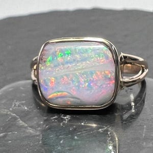 Australian boulder opal ring showing stunning ribbon pattern. Cushion cut  boulder opal statement ring set in 14k yellow gold.