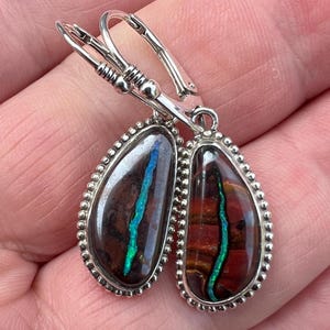 Boulder opal drops in sterling silver with antiqued accented bezel settings. Handmade Australian opal earrings.
