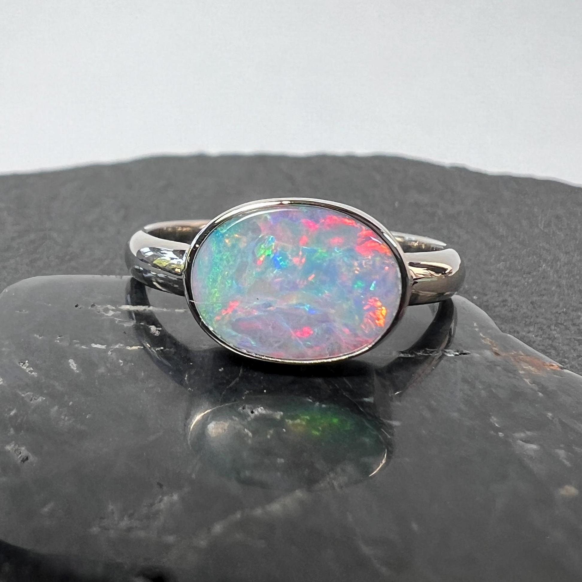 Pastel boulder opal statement ring in 14k white gold. Full face Australian boulder opal bezel set in 14k white gold with large band.