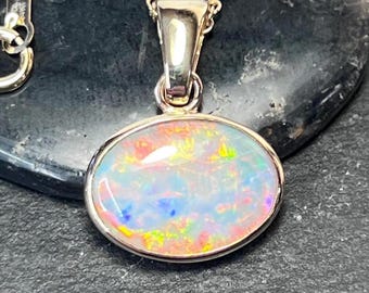 Oval Coober Pedy Fire opal pendant set in 14K yellow gold.