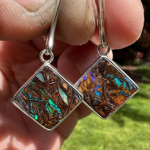 Boulder opal dangle earrings set in sterling silver with lever backs. Natural Yowah Australia boulder opal earrings.