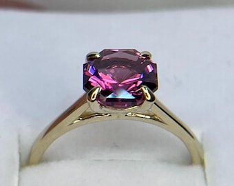 Precision cut octagon Mahenge garnet set in 14K yellow gold.
