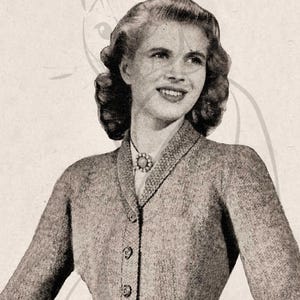 May include: Vintage grey knitted suit with a fitted jacket and matching skirt. The jacket has a notched collar, button fastenings, and a peplum waist. The woman in the image is wearing a necklace.