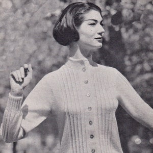 May include: A white knitted sweater with a button-up front and ribbed detailing. The sweater is made with 3-ply yarn and is available in sizes 34-38 inches bust. The text "Holiday Sweater & Jacket" and "P&B Wools" is visible on the image.