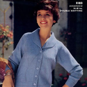 May include: A light blue button-down cardigan with a shawl collar. The image includes text that reads "1183 NINEPENCE 34-40 ins. DOUBLE KNITTING" and the brand name "Templeton's". The cardigan is worn over a dark-colored garment.