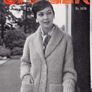 May include: A black and white photograph of a woman wearing a light grey knitted cardigan with a shawl collar and buttons down the front. The cardigan has two pockets. The woman is wearing a scarf tied around her neck. The text "Jaeger Mohair & Wool" is at the bottom of the image. The text "No. 3636" is in the top right corner of the image.