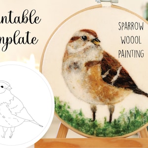 May include: A felted sparrow wool painting displayed in a wooden embroidery hoop. The bird is depicted with brown, tan, and white wool, perched on green felt grass. The words "Sparrow Wool Painting" are written on the hoop.