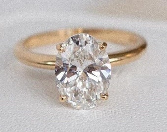 May include: A gold engagement ring with a large oval-shaped diamond.