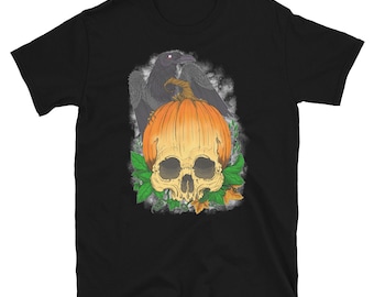 May include: Black t-shirt featuring a Halloween design. The graphic includes a skull, an orange pumpkin, and a black raven. Green leaves and a misty background complete the spooky design. The shirt is made of a soft material.