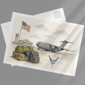 May include: A postcard featuring a watercolor illustration of a U.S. Air Force cargo plane on a runway, with a hangar, an American flag, and a pile of military-style luggage including a duffel bag, a suitcase, a backpack, and a blue cap.