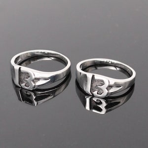 Ring with number 13, in steel.