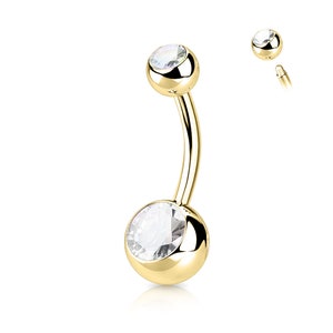 May include: Gold belly button ring with two clear crystal stones.