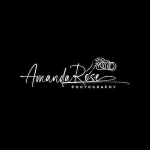 Könnte beinhalten: Ein weißes Strichgrafik-Logo auf schwarzem Hintergrund, das eine Hand mit einem Kameraobjektiv zeigt. Der Text lautet Amanda Rose in einer Schreibschrift, wobei das Wort PHOTOGRAPHY in einer serifenlosen Schriftart unter der Signatur steht.