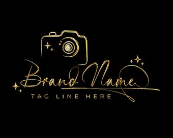 May include: Gold camera outline with sparkling stars and the text "Brand Name" in a handwritten script font with the tagline "TAG LINE HERE" below.