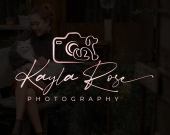 May include: A pink and white logo with a camera and a dog inside the camera. The text "Kayla Rose Photography" is below the logo.