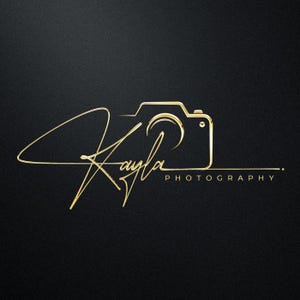 May include: A gold outline of a camera with the word "Photography" below it and a stylized signature that says "Kayla" above the camera.