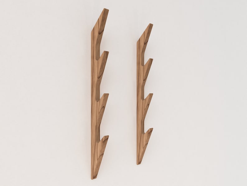 May include: Two wooden wall hooks with a branch-like design. Each hook has four branches that curve upwards, creating a unique and modern look.
