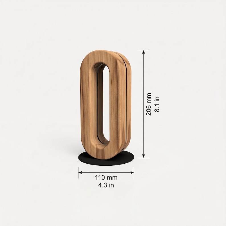 May include: A wooden decorative object in the shape of an elongated oval, standing on a black circular base. The object is 8.1 inches tall and 4.3 inches wide. The wood has a natural grain pattern.