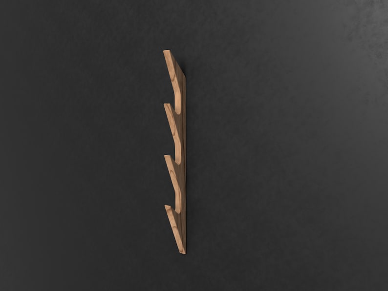 May include: A wooden wall-mounted coat rack with four hooks in a staggered design. The rack is made of light brown wood with a natural grain pattern.