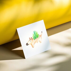 May include: Watercolor illustration of a dog-shaped planter holding green plants. The planter is light brown with a black nose and tail. The plants are a vibrant green, contrasting with the neutral tones of the planter. The image is on a white surface with a yellow background.