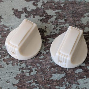 May include: A set of three ceramic nesting bowls in shades of blue, green, and white. The bowls feature a speckled glaze and a simple, modern design. The largest bowl measures approximately 6 inches in diameter.