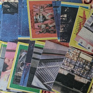 May include: A collection of 24 cards featuring images from a science fiction movie. The cards are yellow, green, and blue with a white border. The text on the cards reads "Collect all 24 cards of puzzle", "Here is what your completed red border puzzle will look like", and "Here is what your completed blue border puzzle will look like".